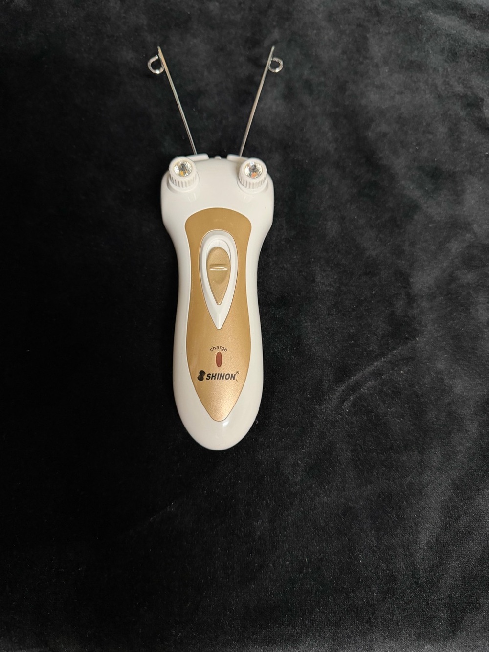 Women’s Gold and White Facial Threading Device